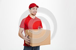 Handsome young delivery man with parcel post box