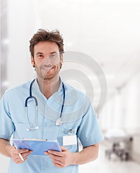 Handsome young doctor on hospital corridor