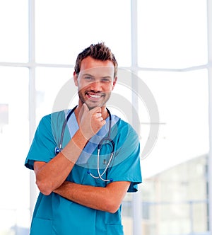 Handsome young doctor isolated smiling at the came