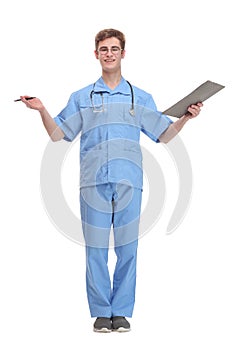 Handsome young doctor in scrubs with stethoscope smiling and holding a clipboard