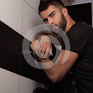 Handsome young elegant man in house interior.