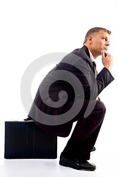 Handsome young executive in deep thought sitting