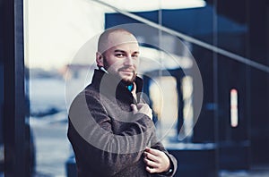 Handsome young fashion model posing on city streets