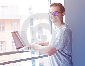 Handsome young freelancer man using laptop computer