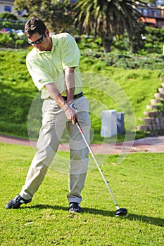 Handsome young golfer in action