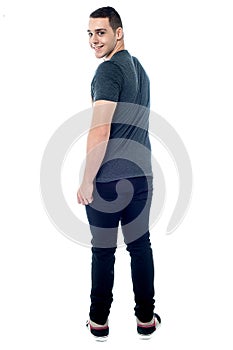Handsome young guy looking back