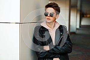 Handsome young guy with sunglasses in a fashionable branded