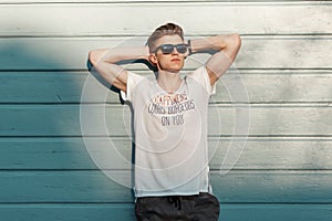 Handsome young hipster man with sunglasses in fashion clothes