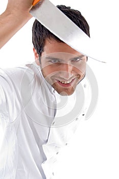 Handsome young male chef smiling holding knife