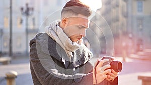 Handsome young male photographer filming video outdoor