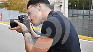 Handsome young male photographer taking photograph