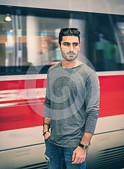 Handsome young male traveler in train station