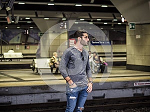 Handsome young male traveler in train station