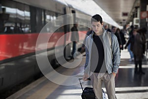 Handsome young male traveler in train station