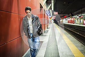 Handsome young male traveler in train station