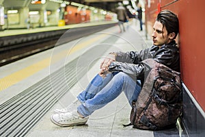 Handsome young male traveler in train station