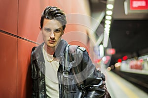 Handsome young male traveler in train station