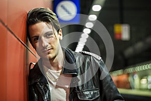 Handsome young male traveler in train station