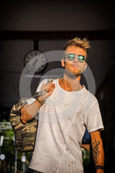 Handsome young male traveler in train station