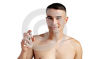 Handsome young man applying perfume on white background