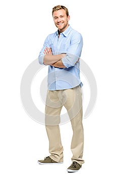 Handsome young man arms folded full length white background