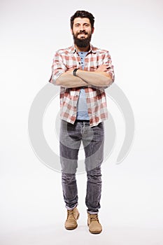Handsome young man with beard full heigh with crossed hands photo