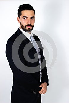 Handsome young man with beard in suit. Attractive stylish businessman.