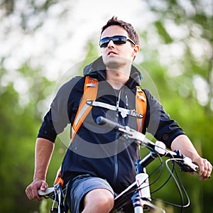 Handsome young man biking