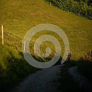 Handsome young man biking on a mountain bike