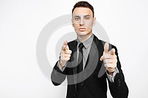 Handsome young man in black suit, fun, smiling, pointing fingers