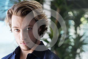 Handsome young man blonde hair and stubble wearing shirt