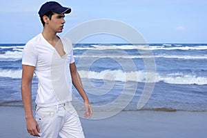 Handsome young man on the blue ocean beach