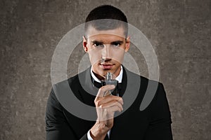 Handsome young man with bottle of perfume