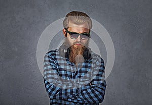 Handsome young man confident student, entrepreneur, arms crossed folded on grey