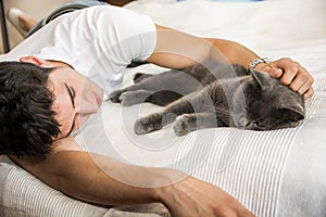 Handsome Young Man Cuddling his Gray Cat Pet