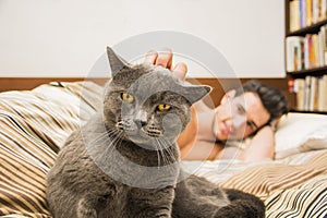 Handsome Young Man Cuddling his Gray Cat Pet