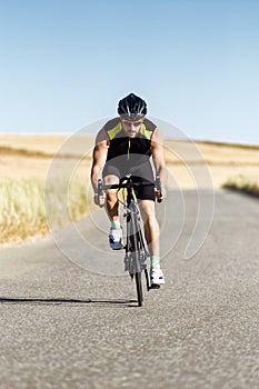 Handsome young man cycling on the road. photo