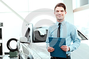 Handsome young man in dealership