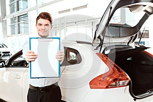 Handsome young man in dealership