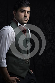 Victorian gentleman posing in a room resembling a study photo