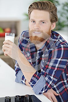 handsome young man drinking milk