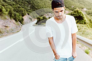 Handsome young man enjoying nature at mountain.