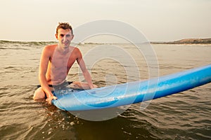Handsome young man enjoying a surf in water.male surfer in the ocean on surf board surfing at beach, freelancer