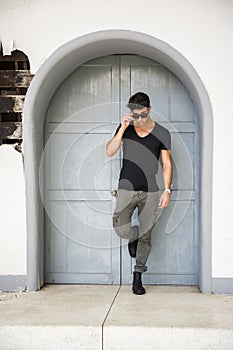 Handsome young man in front of wood door