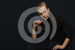 Handsome young man in glasses looking stright into camera photo