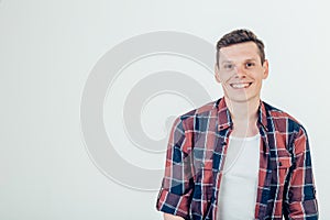 Happy young man. Portrait of handsome young man keeping arms crossed and smiling