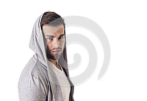 Handsome young man in grey hoodie sweater isolated on white