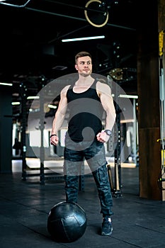 Handsome young man in gym. Fitness muscular man portrait.