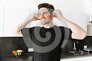 Handsome young man in headphones. Looking aside.