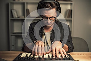 Man working with keyboard controller photo
